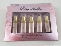 Box showing five lipsticks in their packaging, front view with product name.