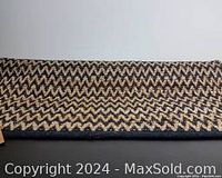 Photo of the full rug showing its zigzag woven pattern and size