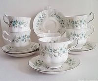 Set of 6 tea cups and 6 saucers arranged with floral design and platinum trim visible
