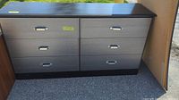 Full view of the dresser showing six drawers, two-tone black and grey finish