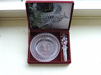 Clear ribbed round crystal dish with matching crystal wine stopper in red presentation box.