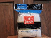 Packaged set of six pairs of Hanes men's extra-thick full foot cushion crew socks in white, size M 6-12.