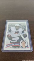 Front of Auston Matthews World Junior rookie hockey card displaying action image, name, position, and team logo.