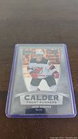 Front of Jack Hughes rookie hockey card in New Jersey Devils uniform, labeled Calder Front-Runners.