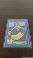 Front of Jose Canseco rookie baseball card in protective sleeve showing player portrait and team logo.