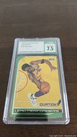 Front view of the encapsulated Kobe Bryant rookie card showing the grading label and card artwork with player performing a dunk.