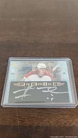 Front view of Marcel Hossa autographed Premier hockey card in a clear hard plastic sleeve.