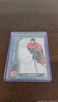Front of the Sam Bennett rookie hockey card showing player image in Calgary Flames uniform and card design details.