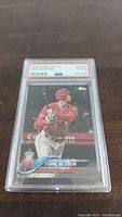 Front view of Shohei Ohtani 2018 Topps Update #US189 rookie card graded PSA 8 in slab showing action batting image and card details.