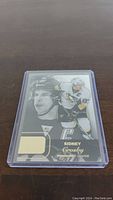 Front view of Sidney Crosby hockey card featuring action and portrait images