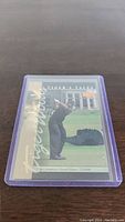 Front of the Tiger Woods Rookie Card showing Tiger in mid-swing with serial number 722/800 visible.