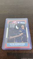 Front of the Victor Wembanyama basketball card showing action dunk photo and team information.