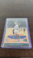 Front of Vince Carter rookie card showing him dunking on court in Toronto Raptors uniform.