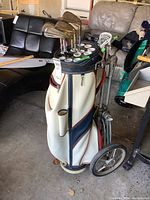Golf bag with cart showing side pockets and clubs inserted