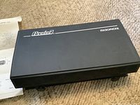 Closed black Prefer carrying case with logo and model text on top, sitting on carpet.