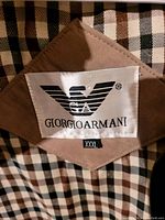 Close-up of Giorgio Armani label inside jacket showing brand logo and size XXXL.