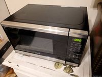 Front view of the Chef microwave oven showing the closed door, digital display is on, control panel on the right side.