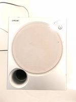 Front view of the white Sony active subwoofer with circular grill and bass port.