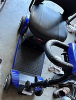 View from front-top showing cushioned vinyl seat, arm rests and foot platform