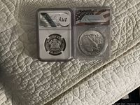 Both coins in protective slabs side by side