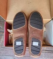 View of black rubber segmented outsole pads and label indicating size 11