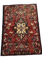 Full front view of rug laid flat on white background showing overall design and wear