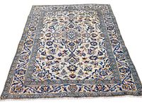 Full view of entire rug laid flat showing border pattern and central medallion