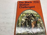 Front cover of the dust jacket showing a colorful horse racing illustration with jockeys and horses exiting the starting gate.