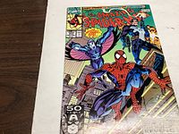 Comic book front cover showing Spider-Man and other characters in action, with title and issue details visible.