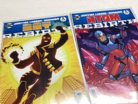 Two DC Comics Justice League Darkseid War Rebirth #1 comics with yellow-black glowing and red-blue armored characters on the covers