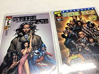 Four Rising Stars comic books with clear plastic protective sleeves, showing various cover artworks including characters in dramatic poses and fantasy settings