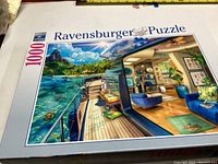 Photo of Ravensburger 1000-piece puzzle box titled 'Houseboat', complete and in good condition.