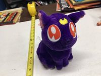 Front angle photo of Sailor Moon Luna plush cat on white surface with measuring tape showing approx 8 inch height