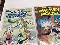 Photo of two Disney comic books, one titled Comics and Stories with Donald Duck on the cover, the other titled Mickey Mouse.