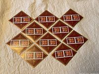 Overview of all 10 diamond-shaped souvenir sheets on fabric background, each with two stamps featuring tiger designs