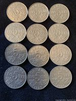 Reverse side of 12 Canadian five-cent coins with 'FIVE CENTS' and 'CANADA' and maple leaf designs.