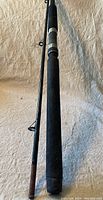 Full view of Shimano fishing rod showing handle, part of the rod blank and line guides on a neutral background.