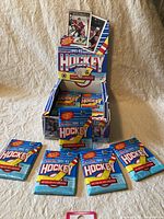 Partial box displaying the 1991-92 OPC hockey card wax packs, some packs removed to show contents.