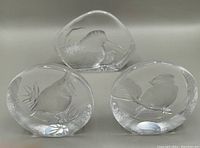 Three Mats Jonasson lead crystal bird sculptures together, showing overall size and shape