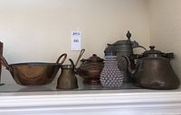 Full overview of all copper and metal vessels including kettles, bowl, pitcher, hobnail glass dispenser, and stein mug.