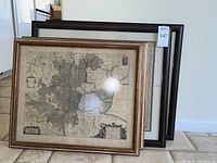 Front view of two Lincolnshire maps in gold-tone frame and the Spain map behind