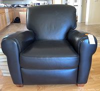 Front view of recliner showing leather upholstery, rolled arms and block feet