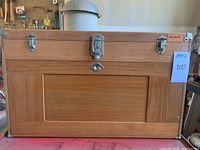 Closed wood chest with metal latches and Gerstner badge