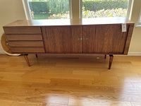 Front elevation showing entire sideboard with drawer stack and cabinet doors.