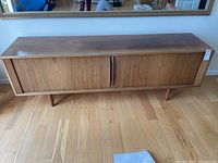 Front view of sideboard with doors closed showing overall design and condition