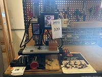 Front view of Sherline Model 2000 drill press showing adjustable table, feed control knob and mounted motor