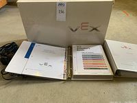 Original VEX v5 box displayed with two binders on concrete floor