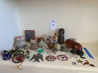 Wide view of all lot items on white shelf under sign