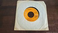 45rpm vinyl record of Elvis Presley song In The Ghetto on RCA Victor label with white paper sleeve