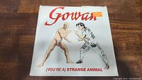 Front cover of the Gowan single showing two illustrated human figures in a fighting stance with red "Gowan" title and song title "(You're A) Strange Animal"